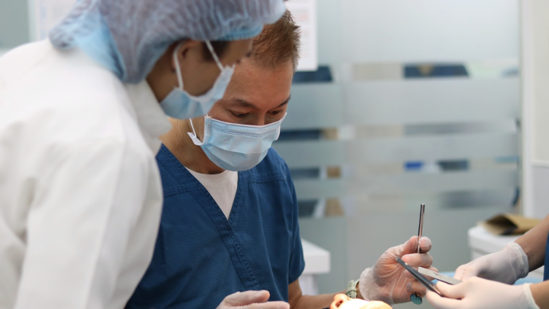 Dr. Andrew H.F. Tsang performing individualized All-on-4 or All-on-6 dental implant surgery