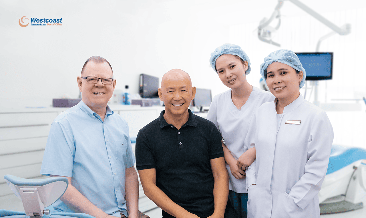 International dental patient smiling comfortably in a modern operatory with the caring clinical team at Westcoast International Dental Clinic Vietnam