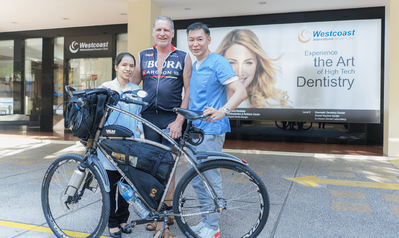 International dental tourists posing with Dr. Andrew outside Westcoast International Dental Clinic in HCMC, Vietnam